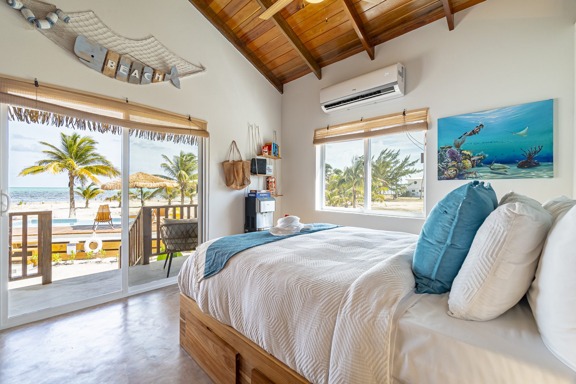 Scuba Room bedroom with sliding doors opening to the porch, pool and sea